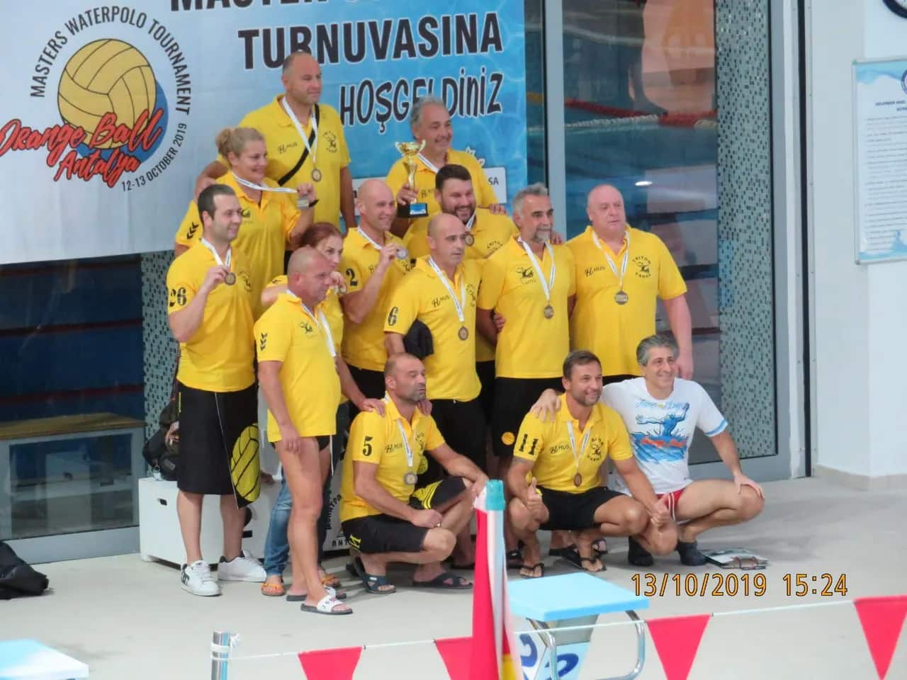 The team with their medals under the tournament banner, Antalya