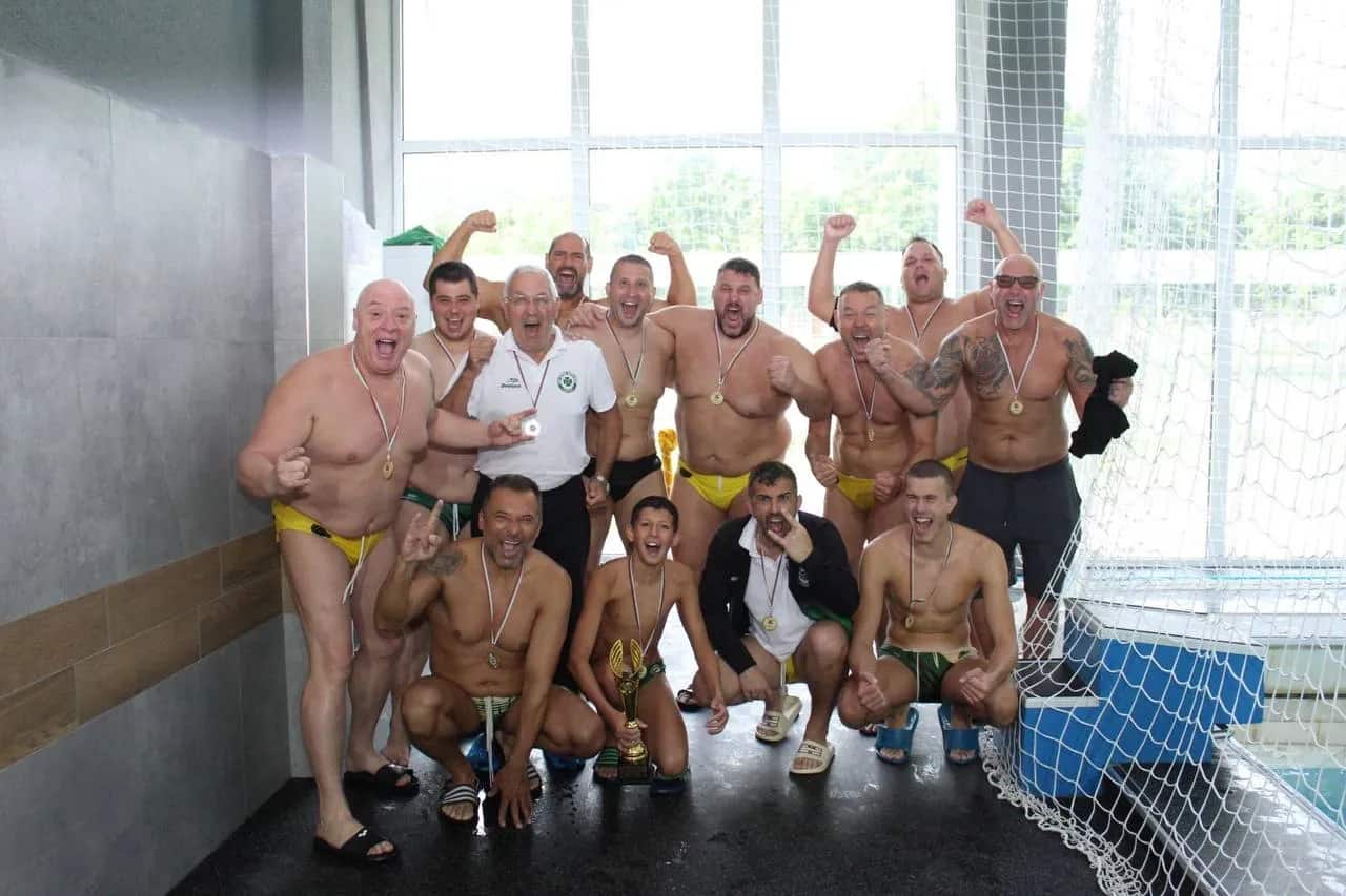 The team in the pool hall with their medals, Division 2
