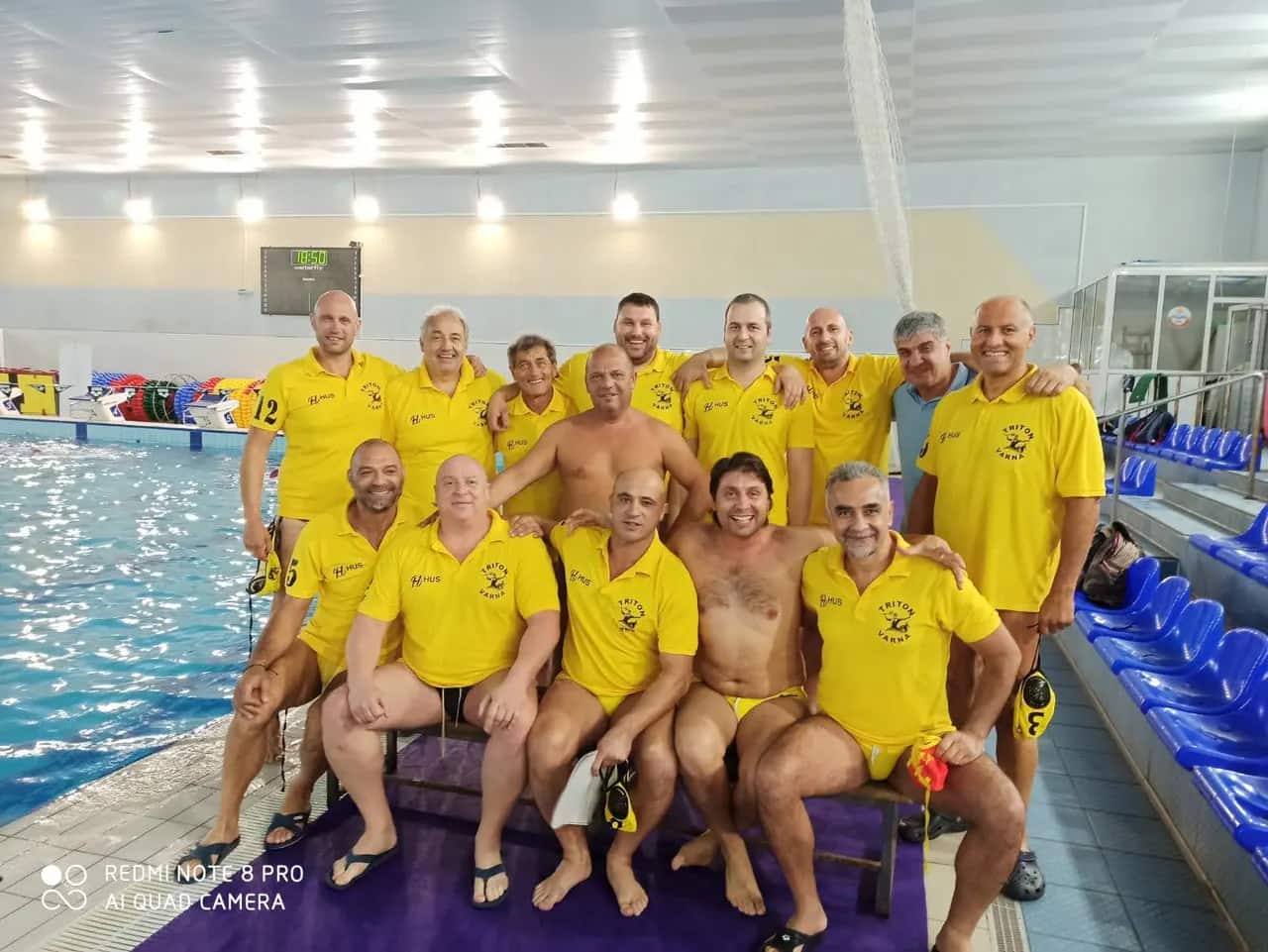 The team in club polos by the pool, Krefeld