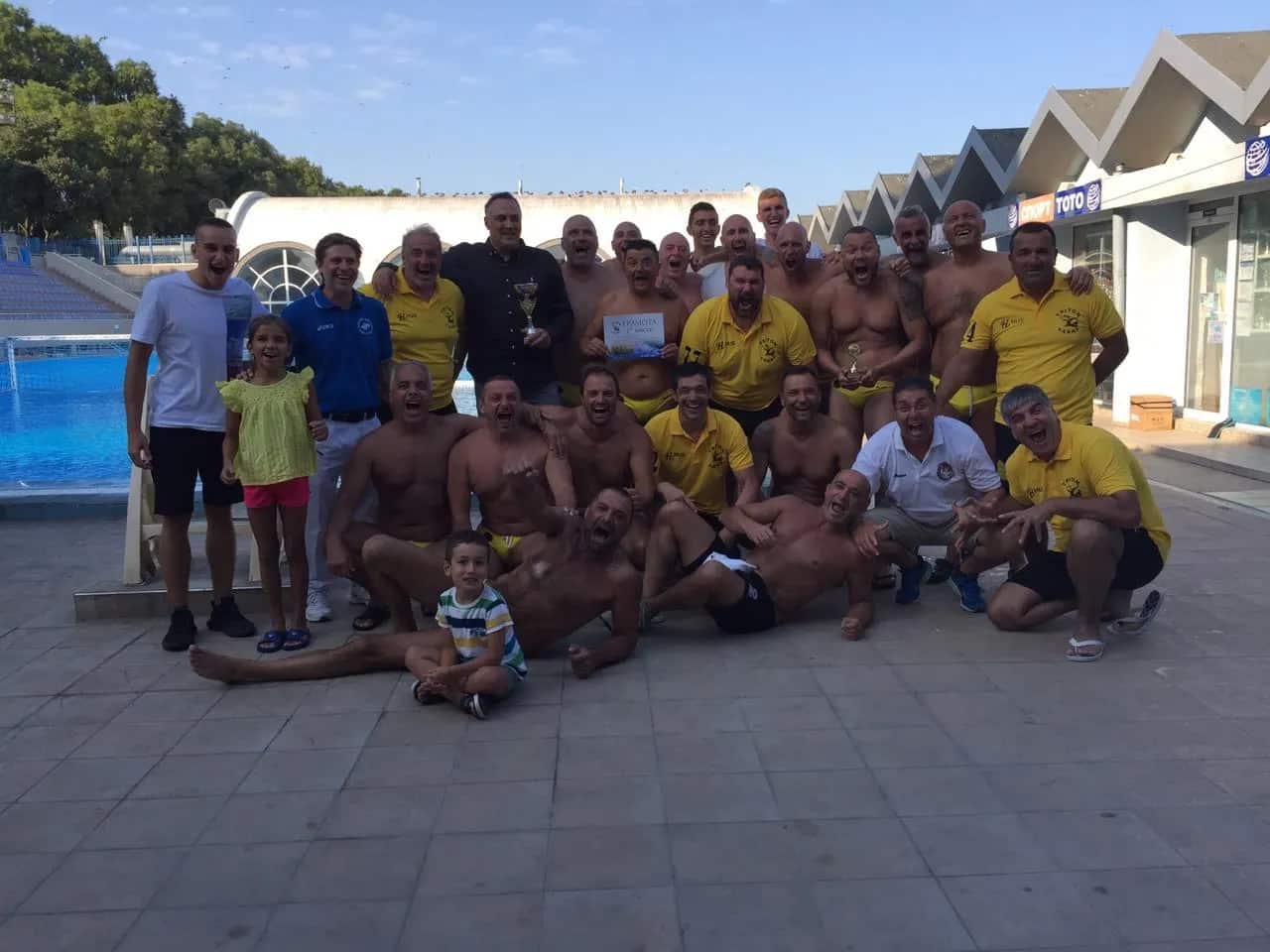 The teams and families with the cups by the Primorski pool