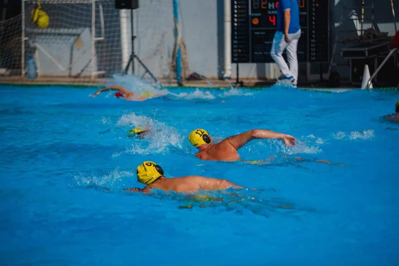Two Triton players swimming on the counter-attack