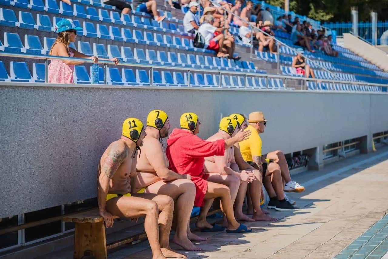 Triton players on the bench below the stands